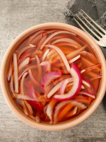 A bowl of quick pickled red onion.